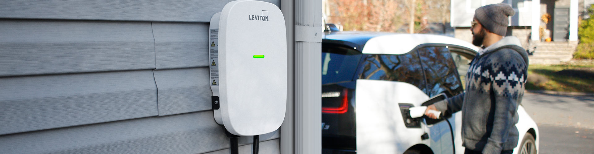 EV Charging Banner Man charging electric vehicle in driveway