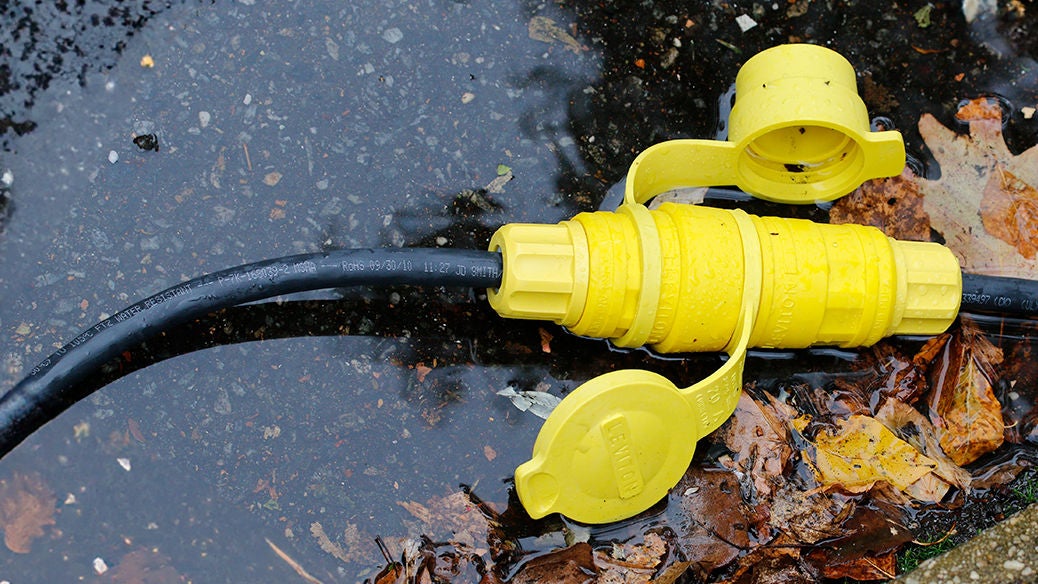 wetguard plug and connector in a puddle with some leaves